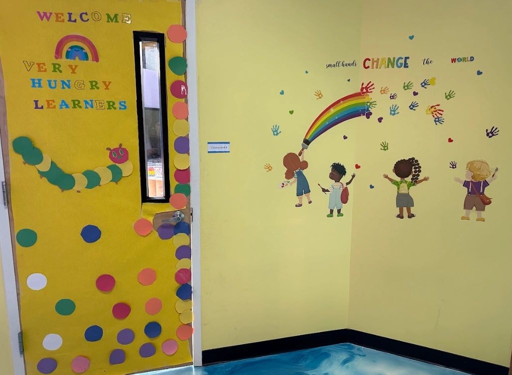 Welcome mural — 'Very Hungry Learners' and 'Small Hands Change the World' classroom wall display